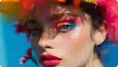 Enhanced photo of a woman featuring blue and orange eyeshadow, red lipstick, and a multicolored feathered headpiece.