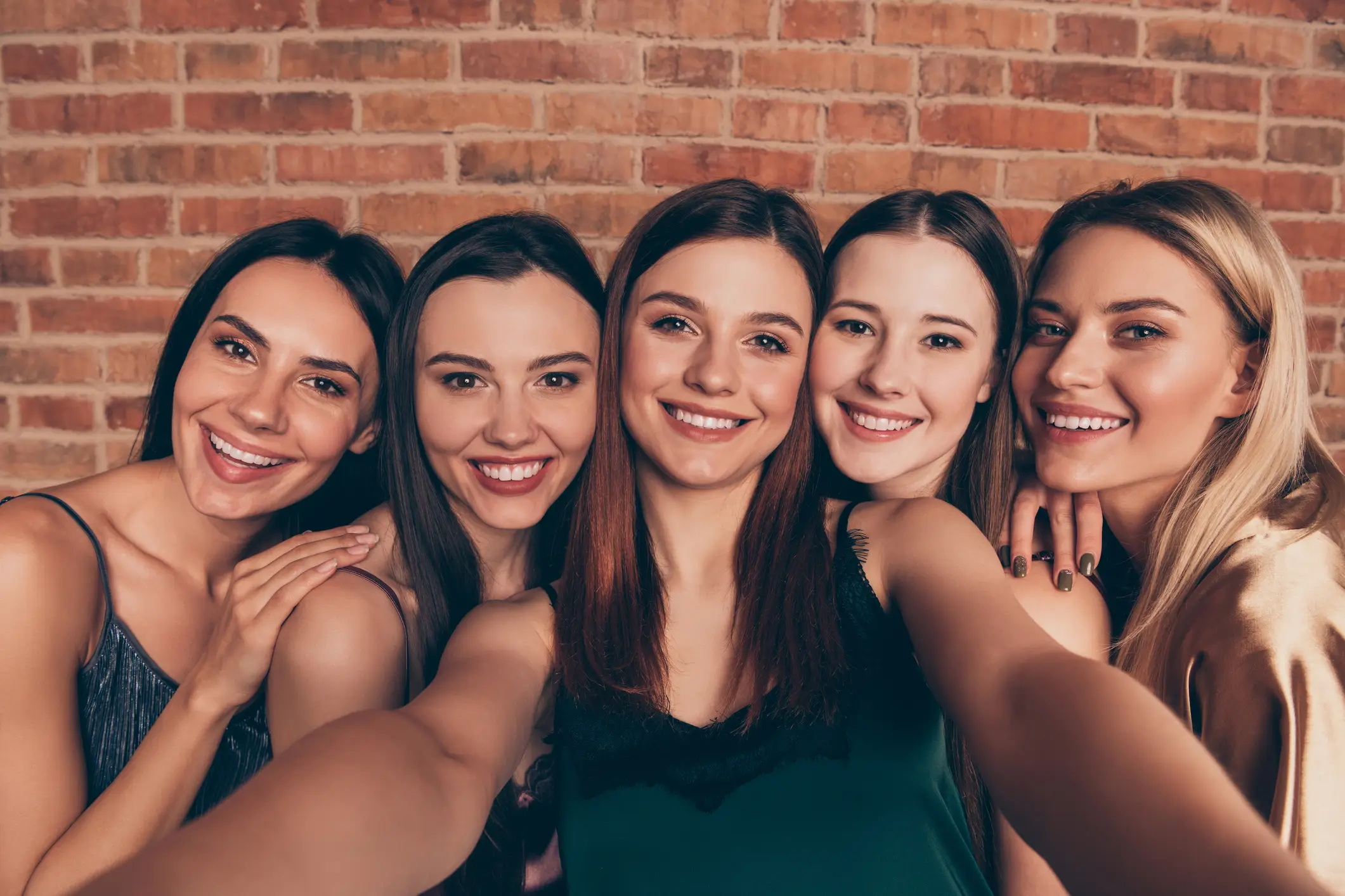 A group of female friends in a group photo, standing together and smiling, which can be used for multiple face swap.
