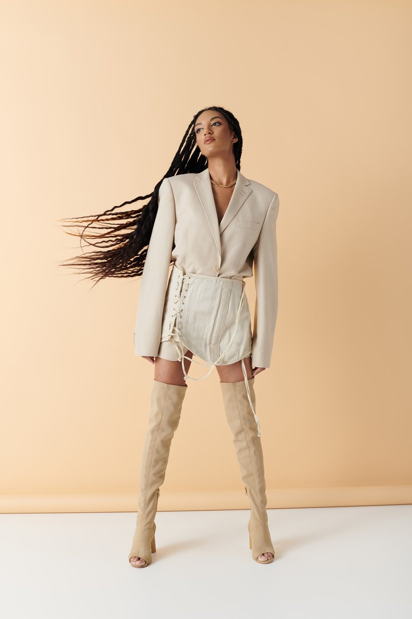 This is a Black female model for clothing swap, with long braided hair. Her face turned to the side, waiting for a clothing change with the AI tool.