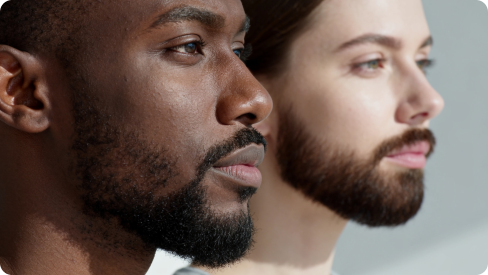 A Black man with a beard and the white woman with a beard standing side by side, demonstrating AI face swap technology.